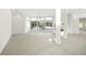 Spacious living room with floor-to-ceiling windows and neutral color palette at 7234 Letitia Ln, Sarasota, FL 34241