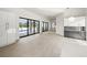 Open floor plan with access to pool area through sliding glass doors, featuring modern cabinetry at 7234 Letitia Ln, Sarasota, FL 34241