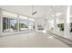 Bright, open living room with fireplace, tile flooring, and expansive windows overlooking the pool at 7234 Letitia Ln, Sarasota, FL 34241
