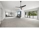 Open-concept living room featuring tile floors, large windows, and a modern fireplace at 7234 Letitia Ln, Sarasota, FL 34241