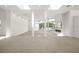 Bright open living room featuring tile flooring and abundant natural light at 7234 Letitia Ln, Sarasota, FL 34241