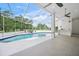 Enclosed pool area featuring a pool, hot tub, and outdoor lounge space at 7234 Letitia Ln, Sarasota, FL 34241