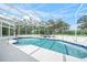 Pool area featuring a swimming pool, and hot tub under an enclosure at 7234 Letitia Ln, Sarasota, FL 34241