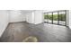 Spacious room with wood floors, white walls, and large windows leading to a balcony at 7234 Letitia Ln, Sarasota, FL 34241