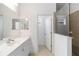 Well-lit bathroom showcasing a modern vanity with sleek fixtures and a tiled shower, offering a clean and inviting space at 7526 Ridgelake Cir, Bradenton, FL 34203