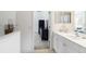 Bright bathroom showcasing a sleek vanity with modern fixtures and a view into an adjacent bedroom at 7526 Ridgelake Cir, Bradenton, FL 34203