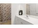 Bright bathroom featuring a white vanity with a white sink and a shower with a themed shower curtain at 7526 Ridgelake Cir, Bradenton, FL 34203