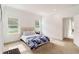 Well-lit bedroom featuring two windows, neutral decor and ensuite bathroom at 7526 Ridgelake Cir, Bradenton, FL 34203