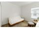Bright bedroom featuring a futon, chair, and desk illuminated by natural light from the window at 7526 Ridgelake Cir, Bradenton, FL 34203