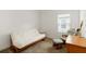 Bright bedroom featuring a futon, chair, and desk illuminated by natural light from the window at 7526 Ridgelake Cir, Bradenton, FL 34203