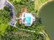 Aerial view of the community pool featuring an inviting pool area, palm trees, and ample seating at 7526 Ridgelake Cir, Bradenton, FL 34203