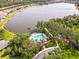 Aerial view of the community pool, beautiful landscaping, and lakeside access at 7526 Ridgelake Cir, Bradenton, FL 34203