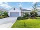 Charming single-story home with a well-manicured lawn and a two-car gray garage door at 7526 Ridgelake Cir, Bradenton, FL 34203