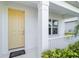 Inviting front porch with a classic yellow door, white trim, and neatly maintained greenery at 7526 Ridgelake Cir, Bradenton, FL 34203