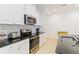 Bright kitchen featuring stainless steel appliances and white cabinets at 7526 Ridgelake Cir, Bradenton, FL 34203
