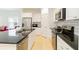 Spacious kitchen featuring stainless steel appliances, black countertops and white cabinets at 7526 Ridgelake Cir, Bradenton, FL 34203