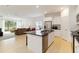 Modern kitchen offering stainless appliances, black countertops, and an open view to the living area at 7526 Ridgelake Cir, Bradenton, FL 34203