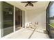 A covered lanai with chairs and a view of another outdoor space via sliding glass doors at 7526 Ridgelake Cir, Bradenton, FL 34203