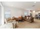Open-concept living area featuring comfortable seating and a view into the modern kitchen space at 7526 Ridgelake Cir, Bradenton, FL 34203