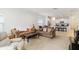 Spacious living room featuring an open layout with a view of the modern kitchen and comfortable seating at 7526 Ridgelake Cir, Bradenton, FL 34203