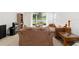Spacious living room with comfortable furnishings, neutral carpet, and a view of the outdoor patio at 7526 Ridgelake Cir, Bradenton, FL 34203