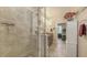 Bright bathroom featuring a tiled walk-in shower, cabinetry, and neutral walls at 8352 Enclave Way # 104, Sarasota, FL 34243