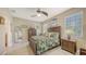 Bedroom featuring a leafy-patterned comforter, dark wood furniture, and neutral colored walls at 8352 Enclave Way # 104, Sarasota, FL 34243