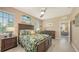 Bedroom featuring a leafy-patterned comforter, dark wood furniture, and neutral colored walls at 8352 Enclave Way # 104, Sarasota, FL 34243