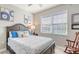 Cozy bedroom featuring a window with blinds, nautical decor, and neutral walls at 8352 Enclave Way # 104, Sarasota, FL 34243