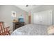 Bedroom featuring a TV, closet, neutral walls, and a tropical-patterned bedspread at 8352 Enclave Way # 104, Sarasota, FL 34243