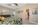 Comfortable bedroom featuring a ceiling fan, neutral walls, and a doorway to a walk-in closet at 8352 Enclave Way # 104, Sarasota, FL 34243