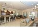 Stylish clubhouse featuring a kitchen, bar seating, and dining tables for social gatherings at 8352 Enclave Way # 104, Sarasota, FL 34243