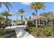 Community entrance with trellis, benches, landscaping, and view of the community at 8352 Enclave Way # 104, Sarasota, FL 34243