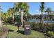 Community grill and ash can for use next to community pool, surrounded by palm trees at 8352 Enclave Way # 104, Sarasota, FL 34243