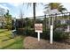 Dog wash station with grass, pet waste station, landscaping, and community fence at 8352 Enclave Way # 104, Sarasota, FL 34243