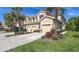 Beautiful multi-story townhome with a private garage, landscaped yard, and tropical palm tree accents at 8352 Enclave Way # 104, Sarasota, FL 34243