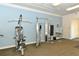 Community gym providing residents with weight machines, a water fountain, and a clock at 8352 Enclave Way # 104, Sarasota, FL 34243