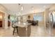 An open-concept kitchen with a large granite island and stainless steel appliances at 8352 Enclave Way # 104, Sarasota, FL 34243