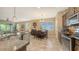 Open-concept kitchen featuring stainless steel appliances and a dining area at 8352 Enclave Way # 104, Sarasota, FL 34243