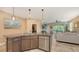 Stylish kitchen island with seating, seamlessly connecting to the living area at 8352 Enclave Way # 104, Sarasota, FL 34243