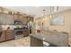 Well-equipped kitchen with stainless steel appliances, granite countertops, and ample cabinet space at 8352 Enclave Way # 104, Sarasota, FL 34243