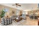Open concept living room with dining area and breakfast bar, neutral colors, and tile flooring at 8352 Enclave Way # 104, Sarasota, FL 34243