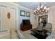Bright living room featuring neutral decor, modern lighting, and a TV for relaxing with guests at 8352 Enclave Way # 104, Sarasota, FL 34243