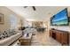 Open concept living room, dining area, and kitchen with stainless steel appliances, light colors and lots of light at 8352 Enclave Way # 104, Sarasota, FL 34243