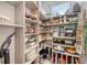 Walk-in pantry featuring open shelves stocked with dry goods, dishes, and small appliances at 8352 Enclave Way # 104, Sarasota, FL 34243