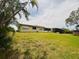 Spacious backyard featuring a well-maintained lawn and a charming home with a screened-in patio at 8508 43Rd W Ave, Bradenton, FL 34209