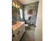 Classic bathroom featuring patterned walls, vanity with sink, and tiled flooring at 8508 43Rd W Ave, Bradenton, FL 34209