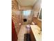 Bathroom featuring a shower with glass doors, tile accent wall, and modern vanity at 8508 43Rd W Ave, Bradenton, FL 34209