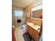 Bathroom featuring a shower with glass doors, tile accent wall, and modern vanity at 8508 43Rd W Ave, Bradenton, FL 34209