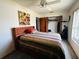 Bedroom features a ceiling fan, natural light, and wood closet doors at 8508 43Rd W Ave, Bradenton, FL 34209